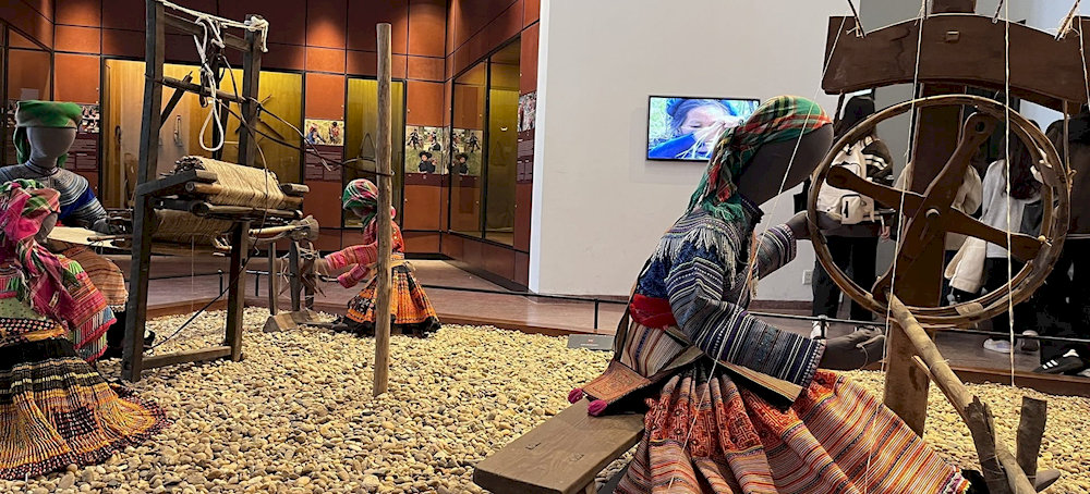 The indoor exhibition area displays tools, everyday items, and traditional costumes of the ethnic groups in Vietnam