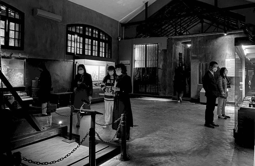 Tourists visiting the interior of Hoa Lo Prison
